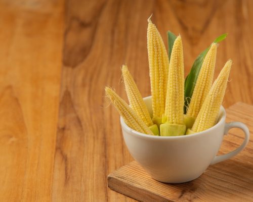 baby-corn-is-placed-glass-wooden-floor