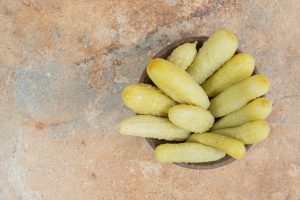 Crunchy pickled cucumbers in wooden bowl. High quality photo