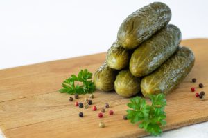 [freepicdownloader.com]-marinated-fermented-cucumbers-gherkins-pickled-cucumbers-with-spices-wooden-board-medium